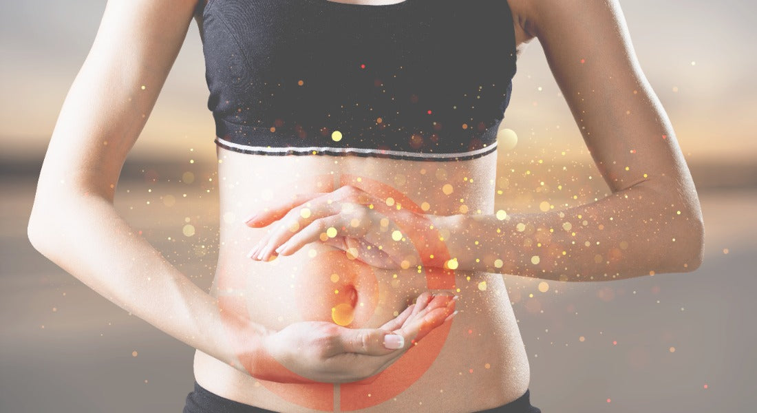 Woman with hands over her abdomen and a glowing swirl over the gut, representing digestive and gut health