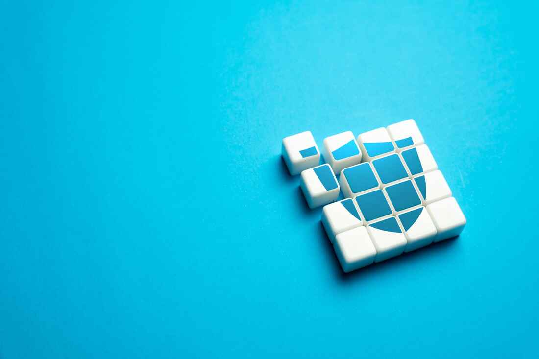 White puzzle blocks forming a shield shape on a light blue background