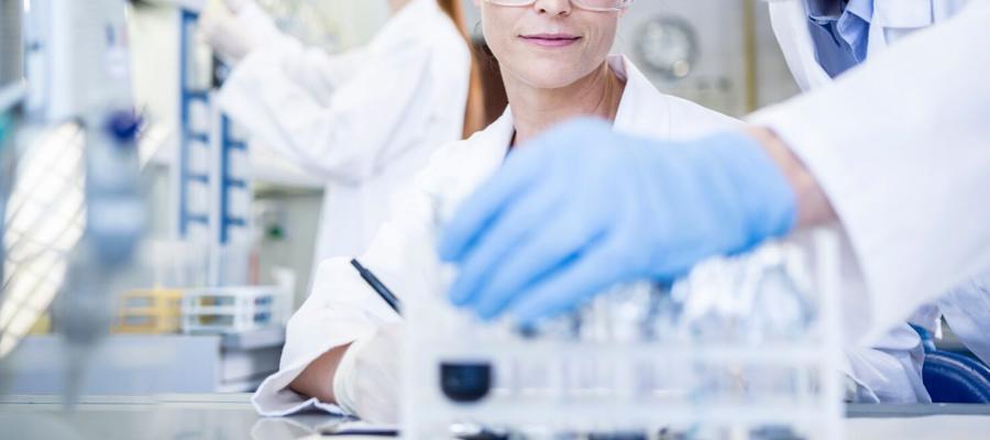 Scientists in lab coats handling test tubes in a laboratory, representing research on potassium and health
