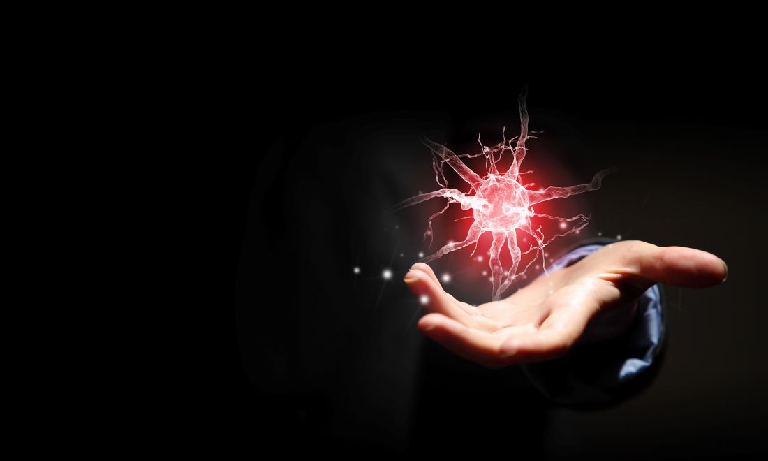 Hand holding a glowing illustration of a nerve cell, representing the vagus nerve and nervous system health